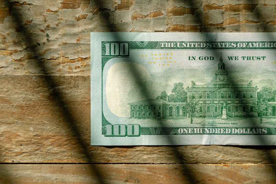 US Currency One hundred dollar bill flat lay on wood background